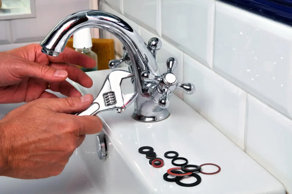 Plumber performing maintenance on a bathroom faucet in Jacksonville