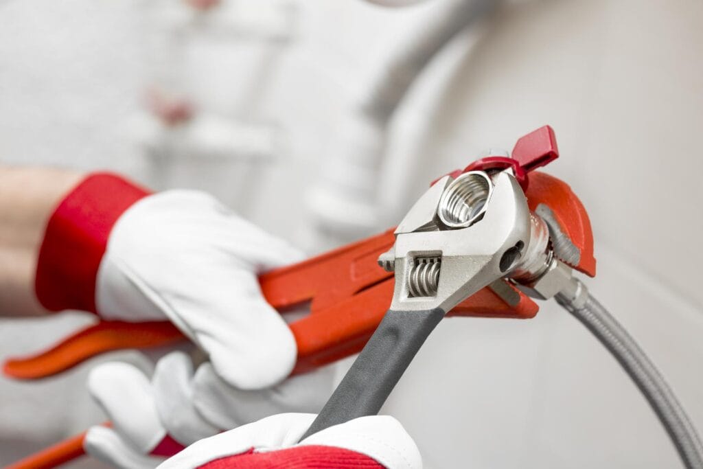 Plumber holding pipe wrenches for an emergency repair in Jacksonville