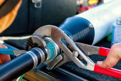 Technician tightening an industrial pipe connection in Jacksonville
