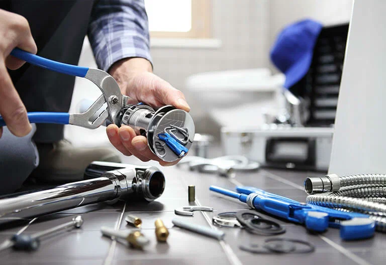Technician repairing a plumbing fixture with professional tools in Jacksonville