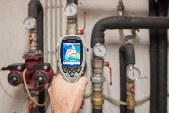Plumber using a thermal imaging camera to inspect pipes in Jacksonville