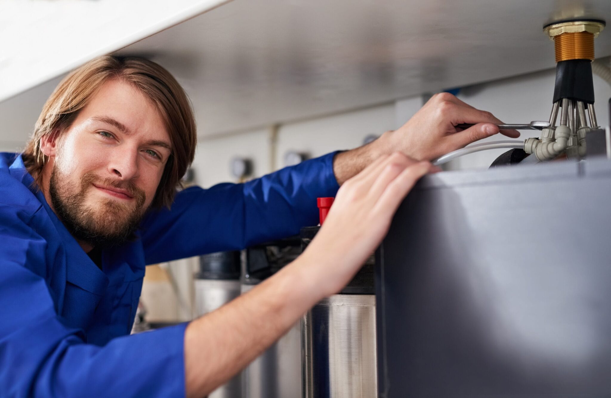 Technician servicing a residential water heater tank in Jacksonville